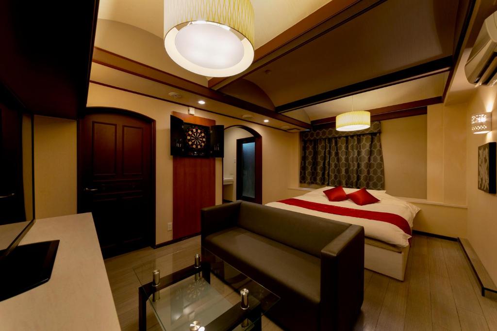 Postel nebo postele na pokoji v ubytování Hotel Lotus Sakai (Adult Only)