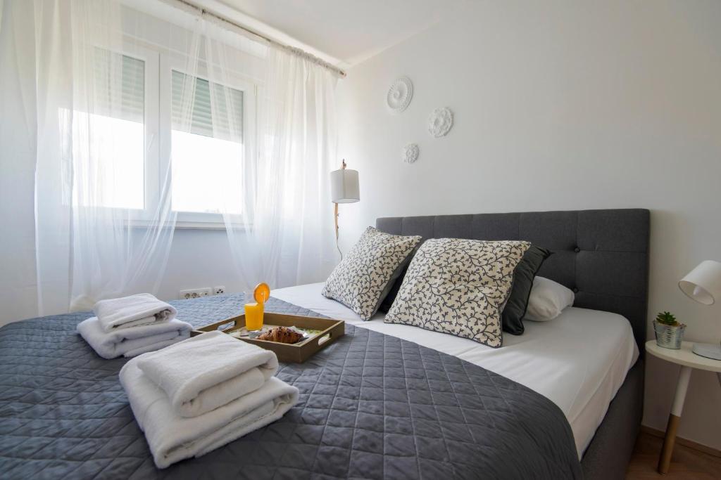 Posteľ alebo postele v izbe v ubytovaní Apartment Lita Center