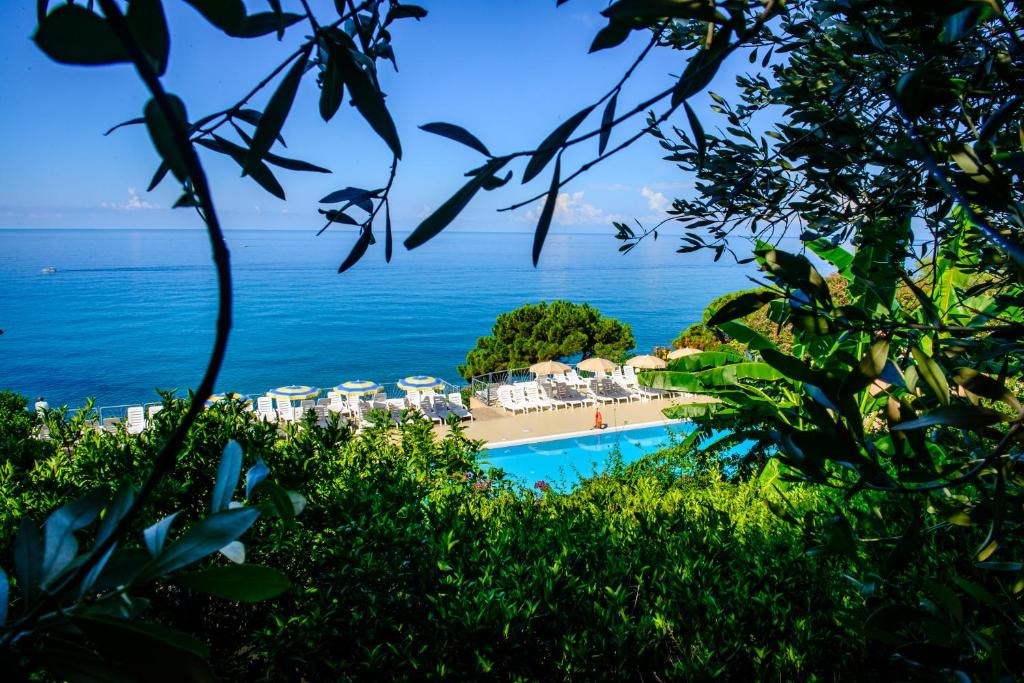 a view of a beach with a resort and the ocean at Lido Paradiso Resort in Pisciotta