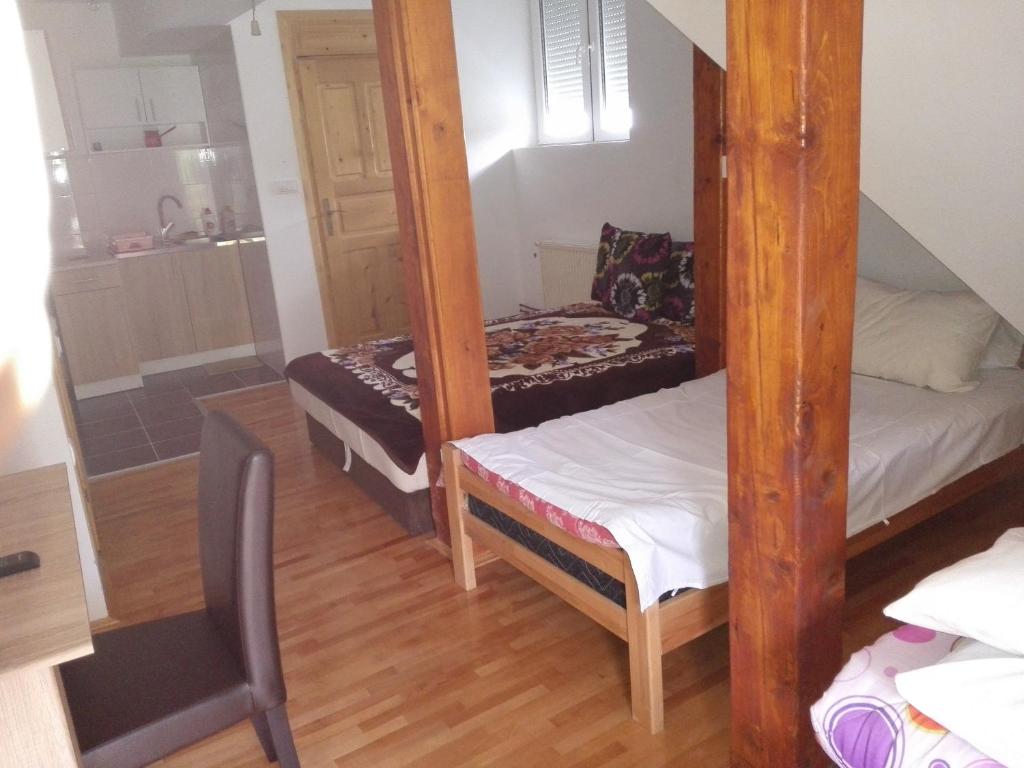 a small room with two bunk beds and a kitchen at Pešić Apartmani in Kušići