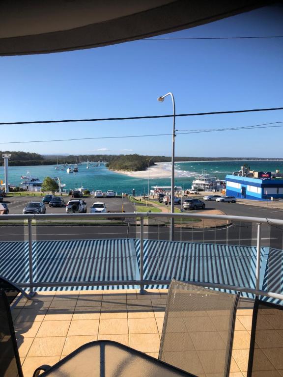 a balcony with a view of the ocean and a highway at Quelle Vue Huskisson in Huskisson