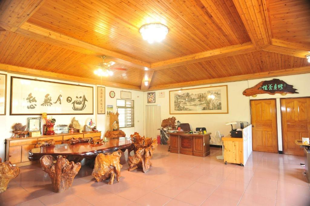 a large room with a table and wooden ceilings at Jia Jia Homestay in Yuli