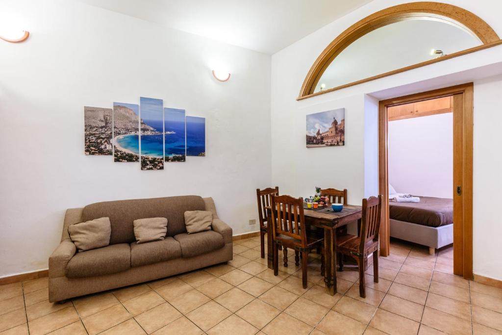 a living room with a couch and a table at Pilly House Vucciria in Palermo