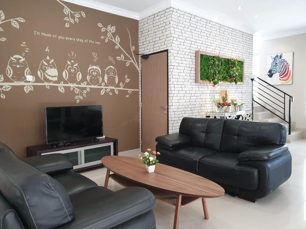 a living room with a couch and a table at Danka@Taman Golf Residence in Batam Center