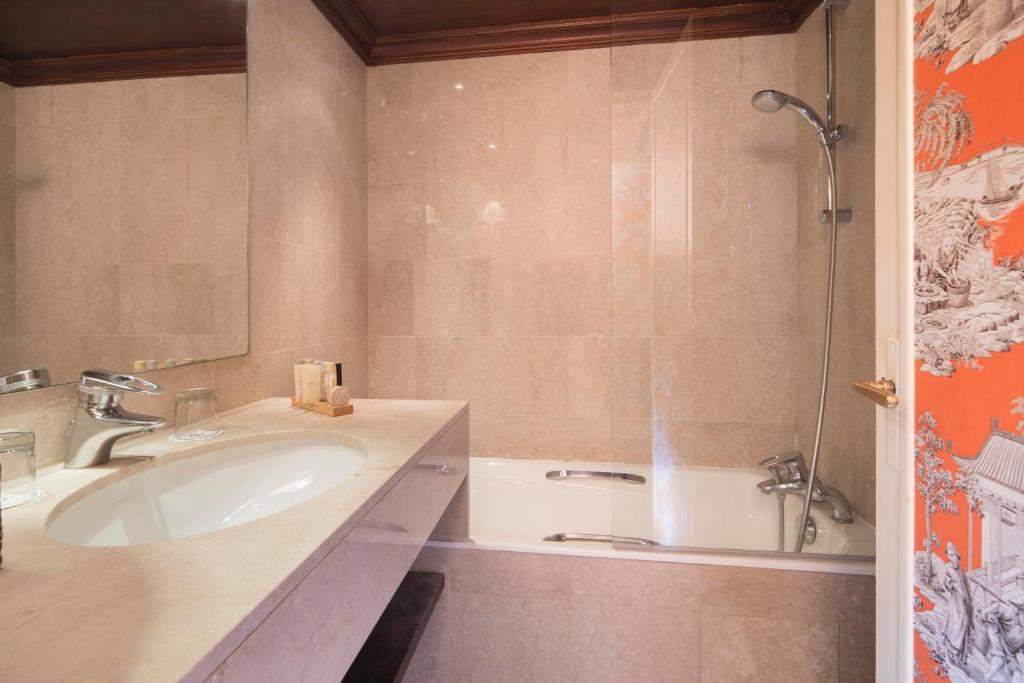 a bathroom with a sink and a shower at Hôtel du Danube Saint Germain in Paris