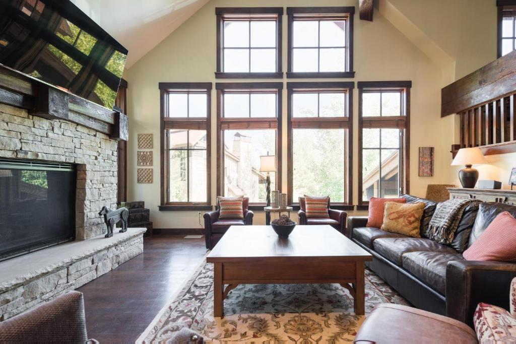 a living room with a couch and a tv at Silver Star #04 - 6 Bed Cottage in Park City