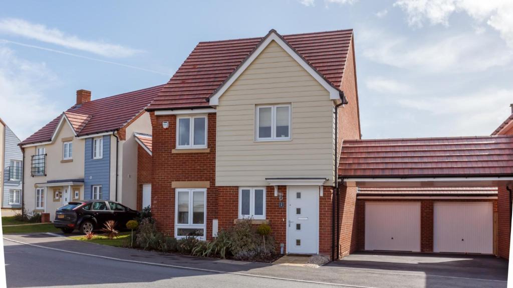 a house with a garage in a residential neighborhood at Heath Reach in Poole