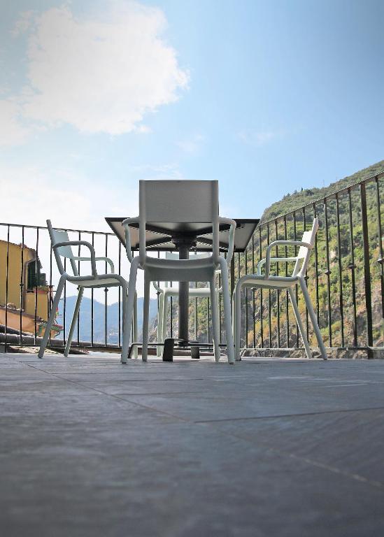 two chairs and a table on a patio at MADA Charm Apartments Terrace&Carugio in Vernazza