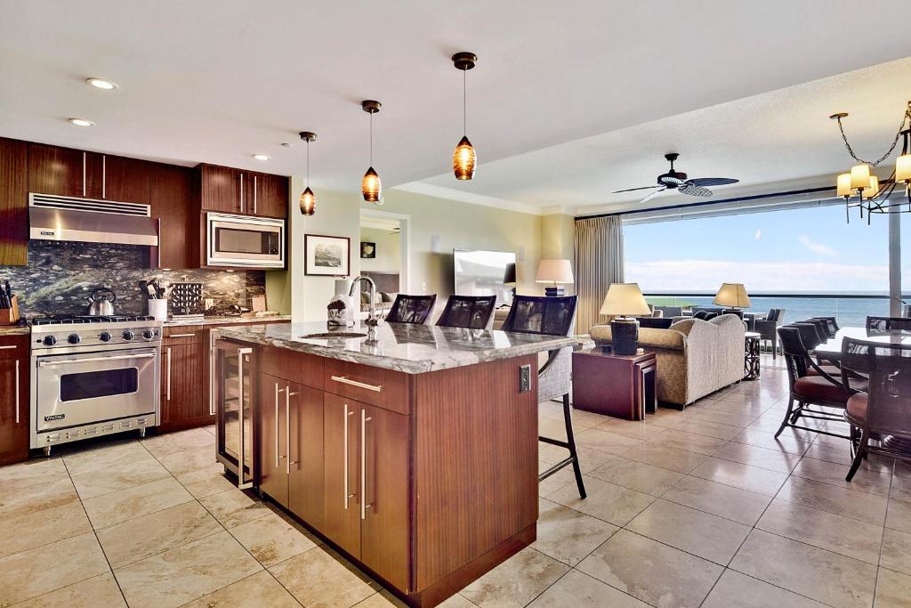 a kitchen and living room with a view of the ocean at Honua Kai - Hokulani 829 in Kaanapali