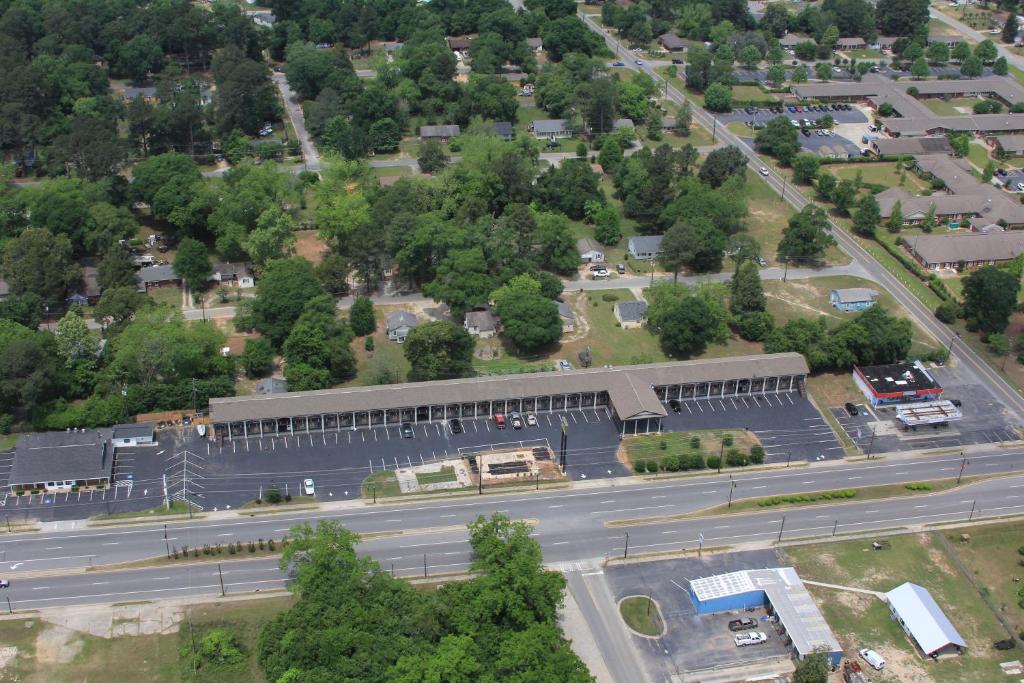 an aerial view of a building with a parking lot at Scottish Inn and Suites Perry in Perry