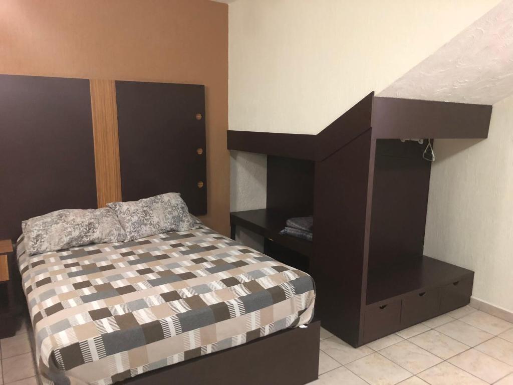 Postel nebo postele na pokoji v ubytování Hotel del Carmen