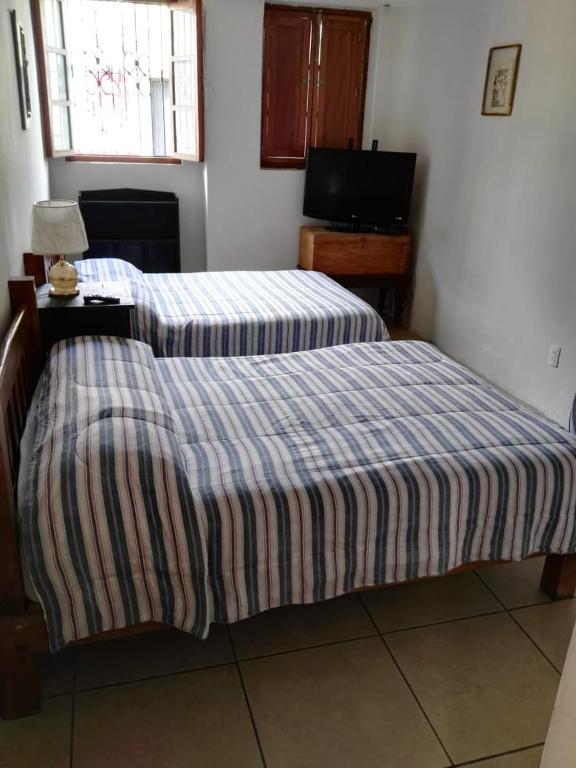 Postel nebo postele na pokoji v ubytování Olga Querida B&B Hostal