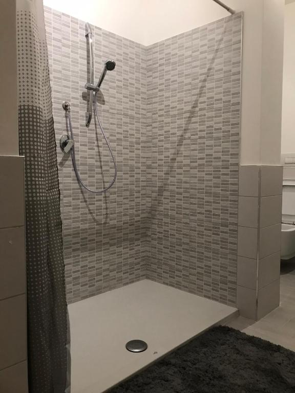 a bathroom with a shower with a shower curtain at Bari Lory’s Home in Bari