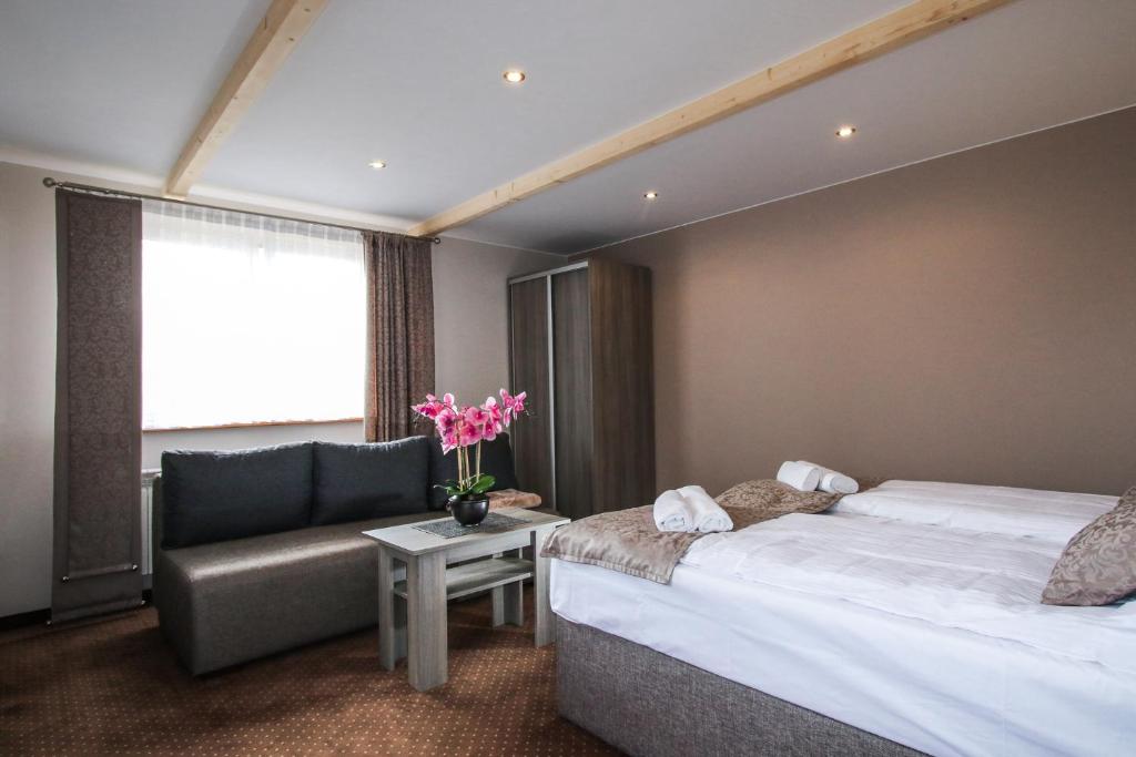 Posteľ alebo postele v izbe v ubytovaní Ania Apartamenty