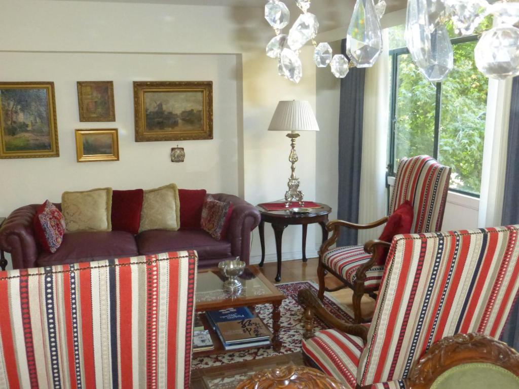 sala de estar con sofá y 2 sillas en Plaza Huelen en Santiago