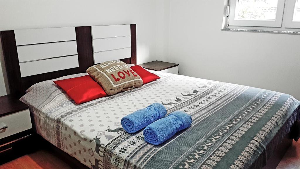a bedroom with a bed with two pillows on it at Tetovo Apartment Superb Location in Tetovo