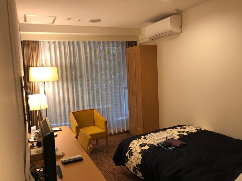 Postel nebo postele na pokoji v ubytování New Welcity Yugawara