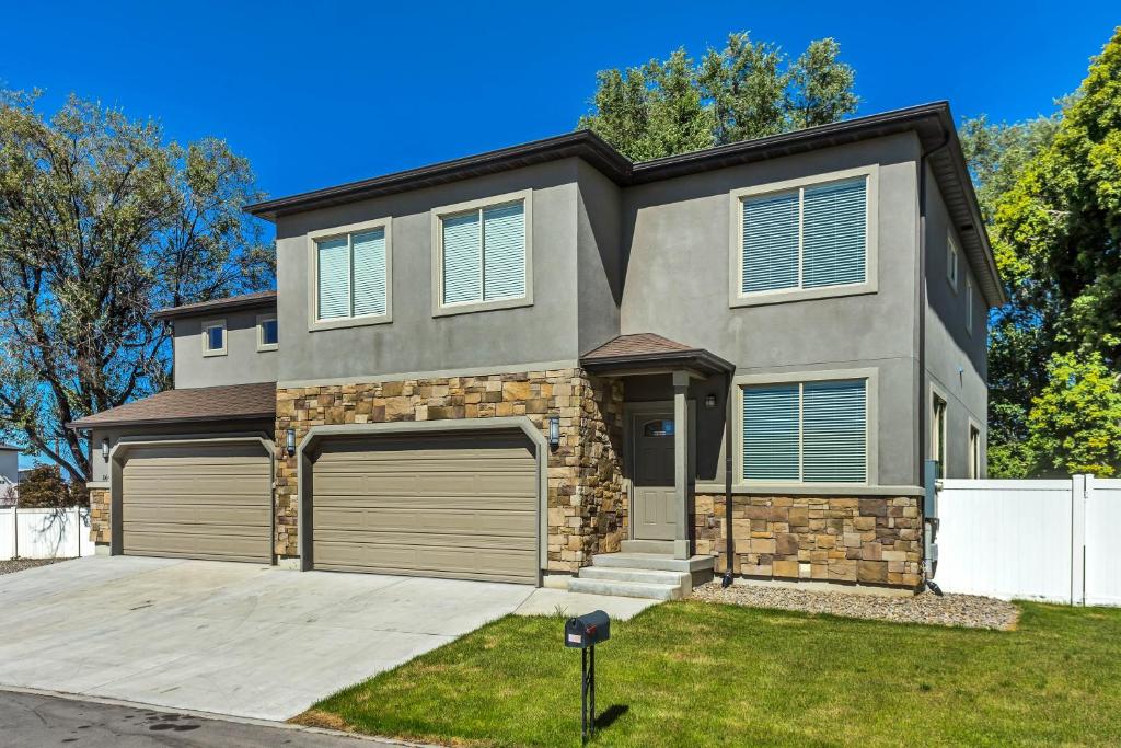 a house with two garage doors in a yard at Spacious & New Guesthouse in Orem/Provo in Orem