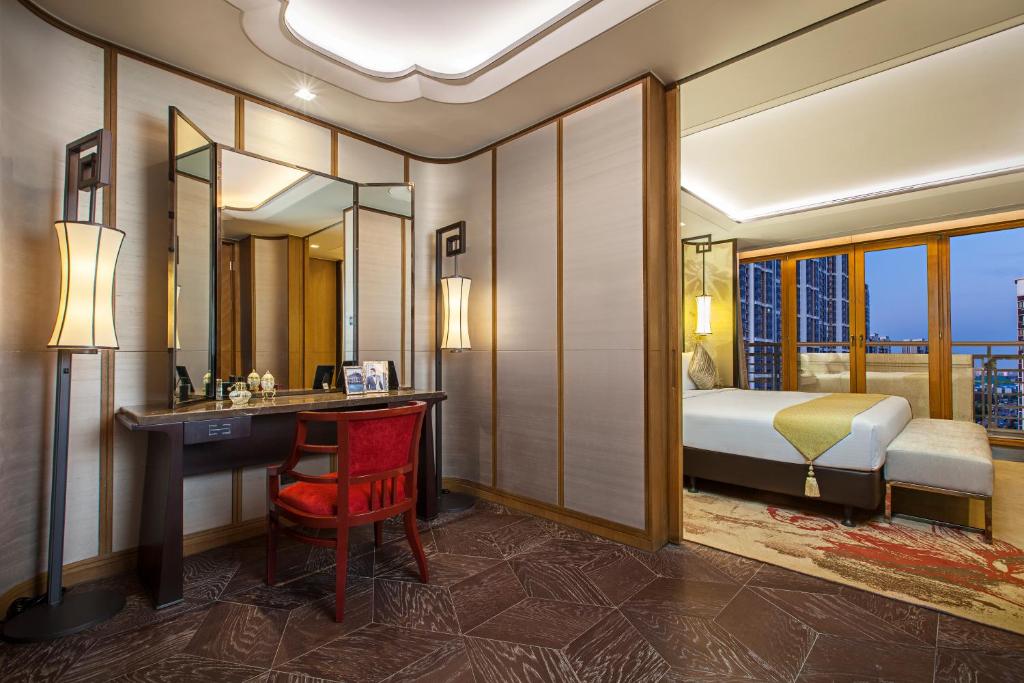 a hotel room with a bed and a desk and a bedroom at Ascott Riverside Garden Beijing in Beijing