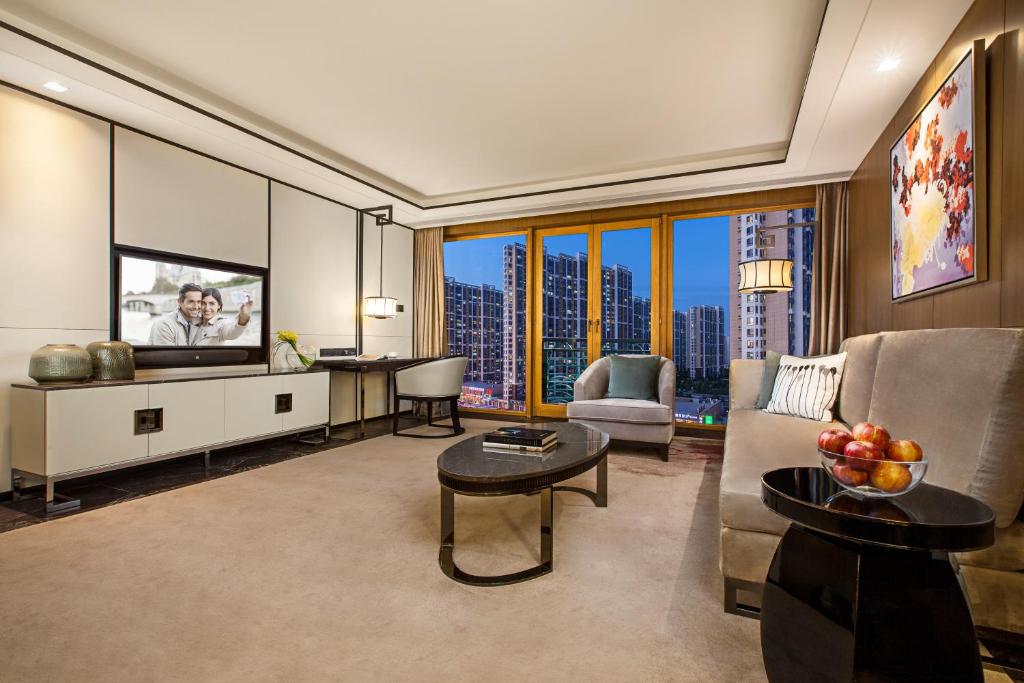 a living room with a couch and a tv at Ascott Riverside Garden Beijing in Beijing