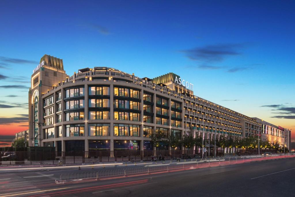 a large building on a city street at dusk at Ascott Riverside Garden Beijing in Beijing