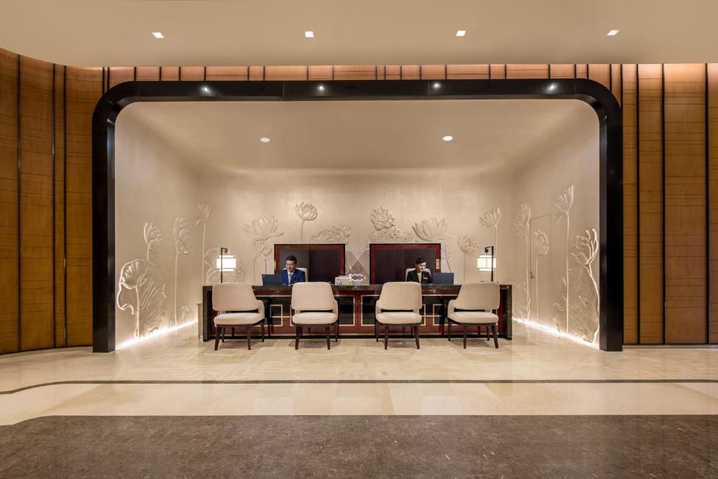 a meeting room with a table and chairs in a lobby at Ascott Riverside Garden Beijing in Beijing