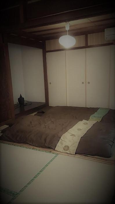Postel nebo postele na pokoji v ubytování 石垣島 一棟貸切りのお宿 ちゅら赤瓦