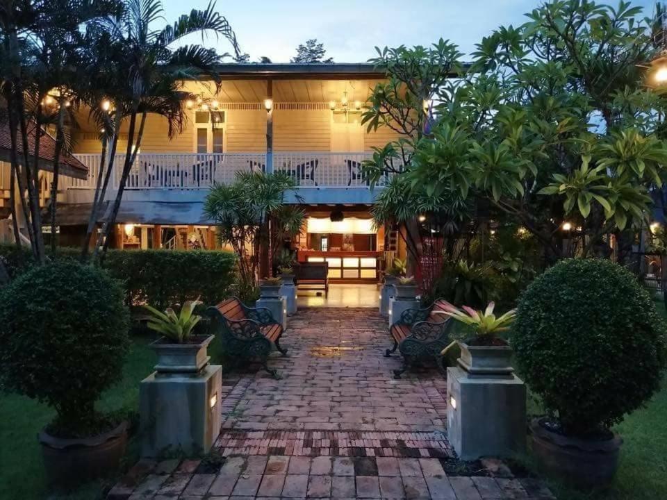 a house with a brick walkway in front of it at Dorm of Happiness by Tharaburi Resort in Sukhothai