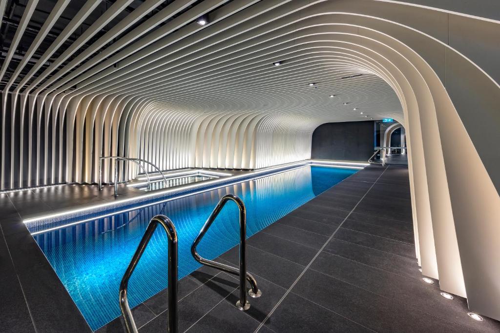 a swimming pool with blue lighting in a tunnel at SKYE Suites Sydney in Sydney