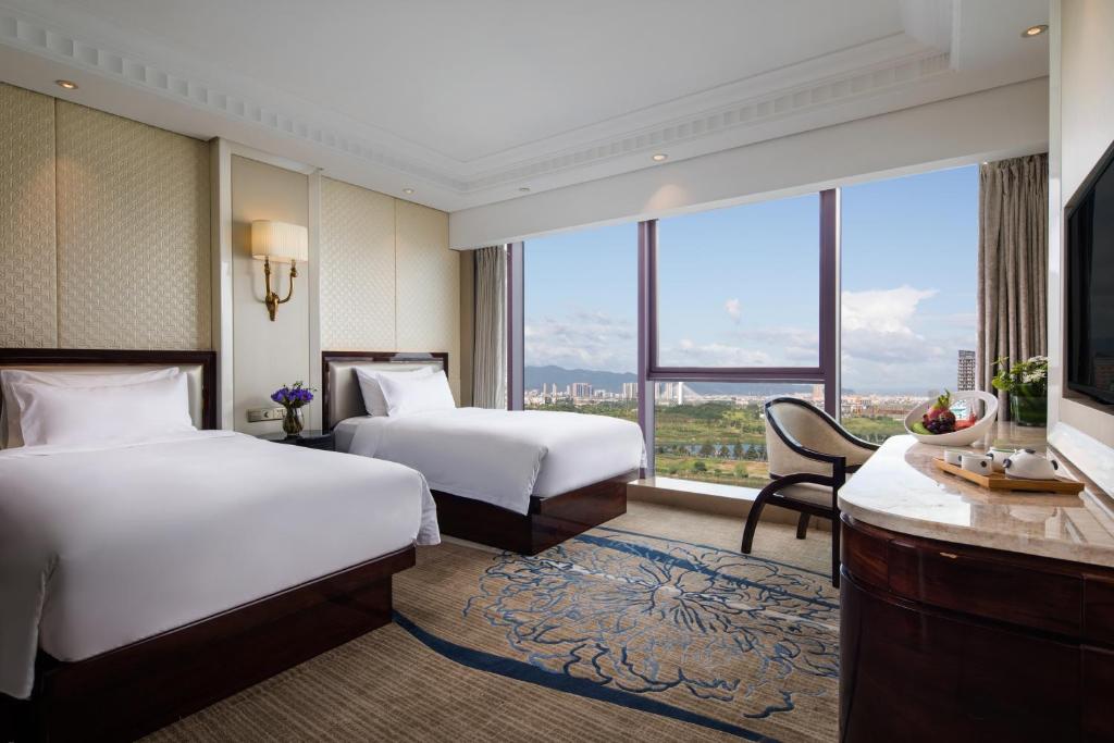 Postel nebo postele na pokoji v ubytování Kasion International Hotel Yiwu