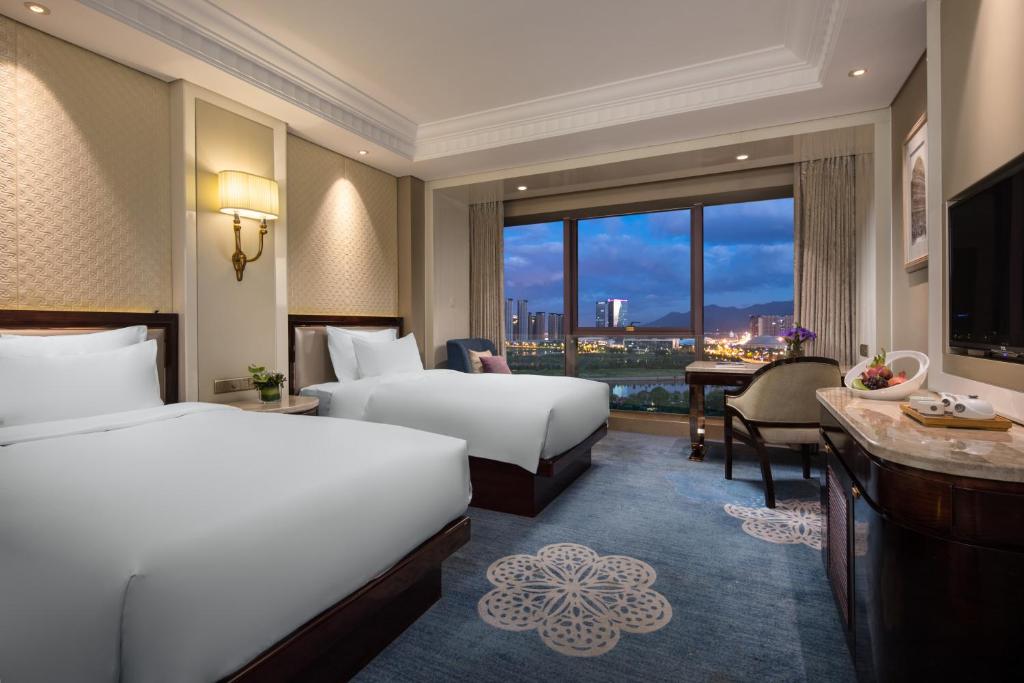 Postel nebo postele na pokoji v ubytování Kasion International Hotel Yiwu