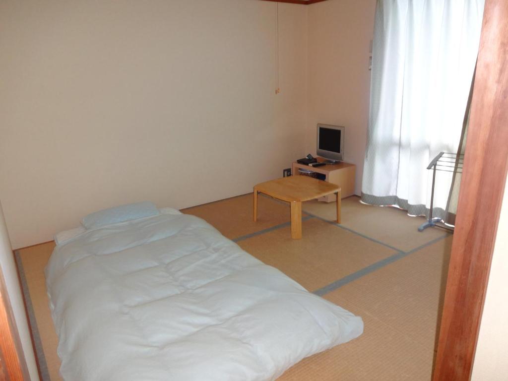 Postel nebo postele na pokoji v ubytování 海のお宿