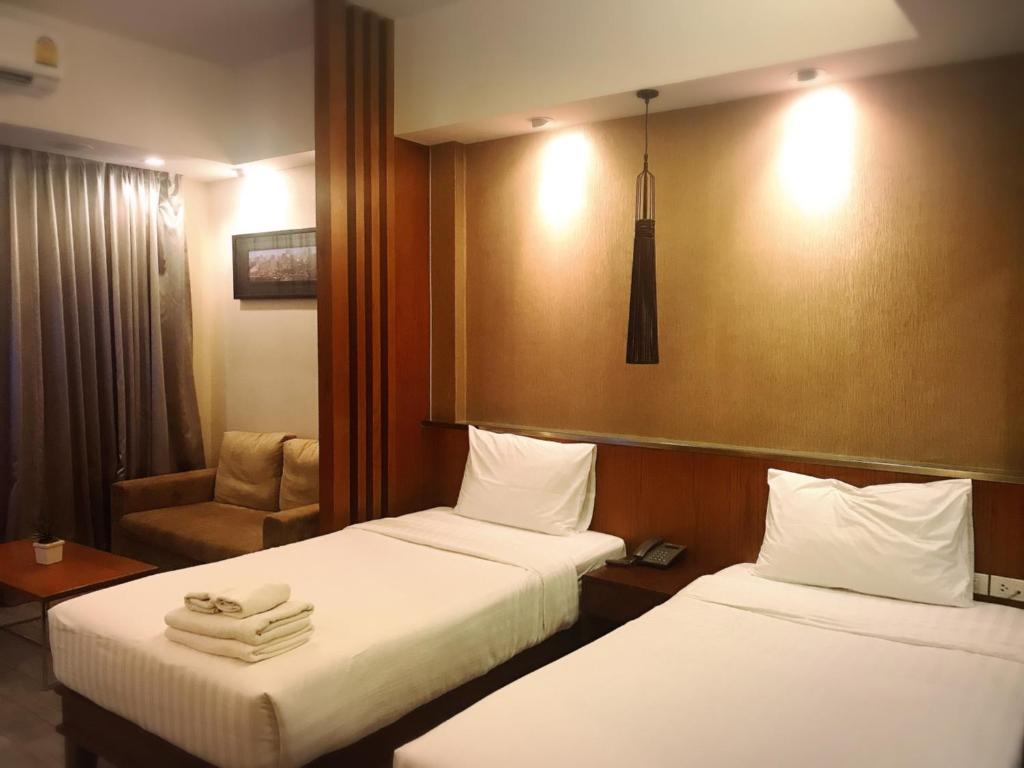 Postel nebo postele na pokoji v ubytování Inn Residence Serviced Suites - SHA Extra Plus