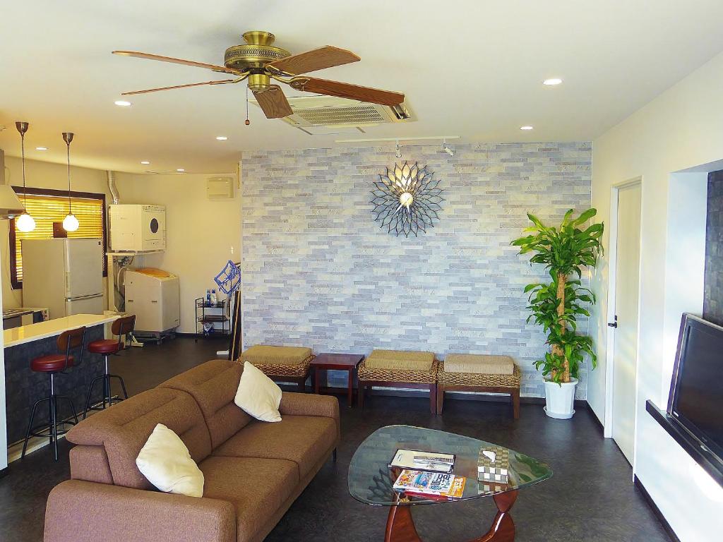 a living room with a couch and a table at ウィークリー・マンスリー SORA in Miyako Island