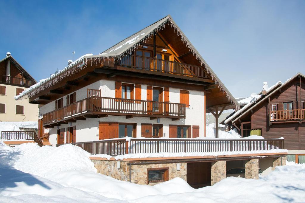 a large house with snow in front of it at Maison Gauthier in Puy-Saint-Vincent