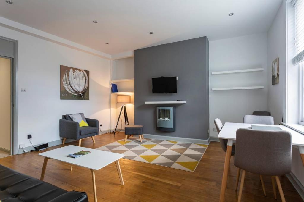 a living room with a couch and a table at Spacious Central Chic Apartment - Simply Check In in Winchester