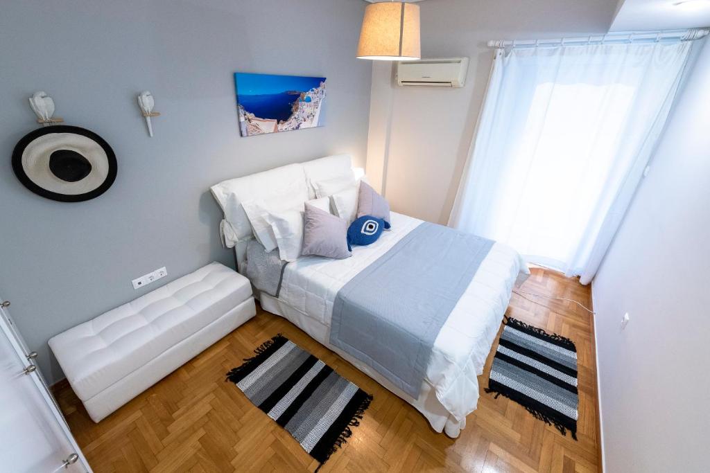 a small bedroom with a bed and a window at Piraeus Port Marouso in Piraeus