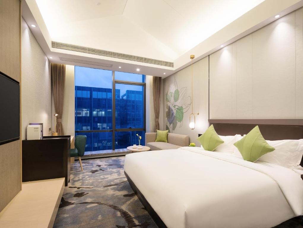 Postel nebo postele na pokoji v ubytování Buddy Hotel-Free Shuttle to Canton Fair Complex during Canton Fair Period