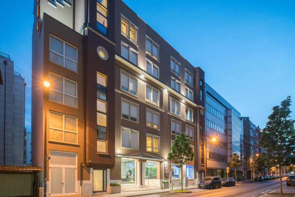 a tall black building on a city street at night at Best Western Plus Grand Hotel Victor Hugo in Luxembourg