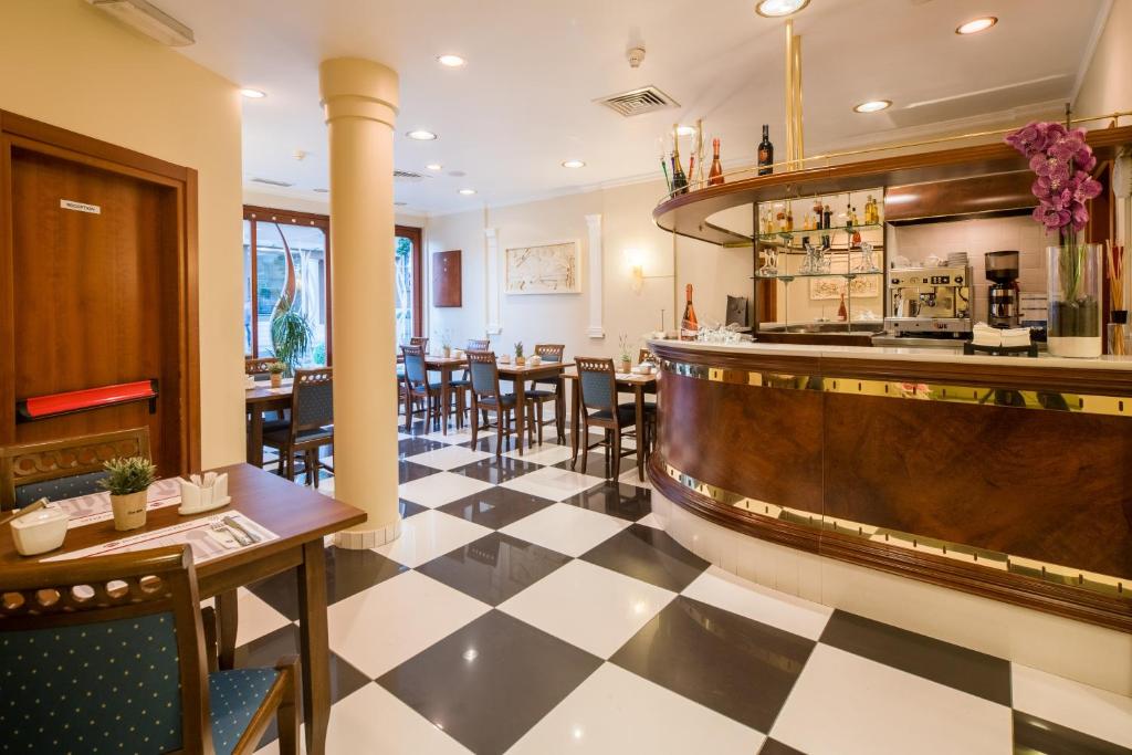a restaurant with a black and white checkered floor at Best Western Plus Grand Hotel Victor Hugo in Luxembourg
