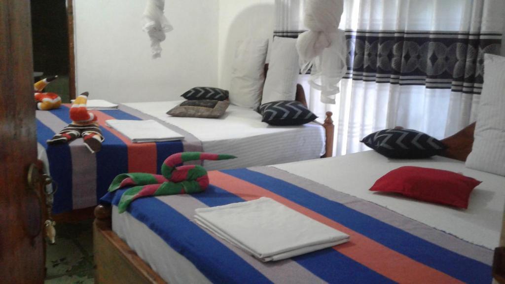 Postel nebo postele na pokoji v ubytování Kalana Homestay