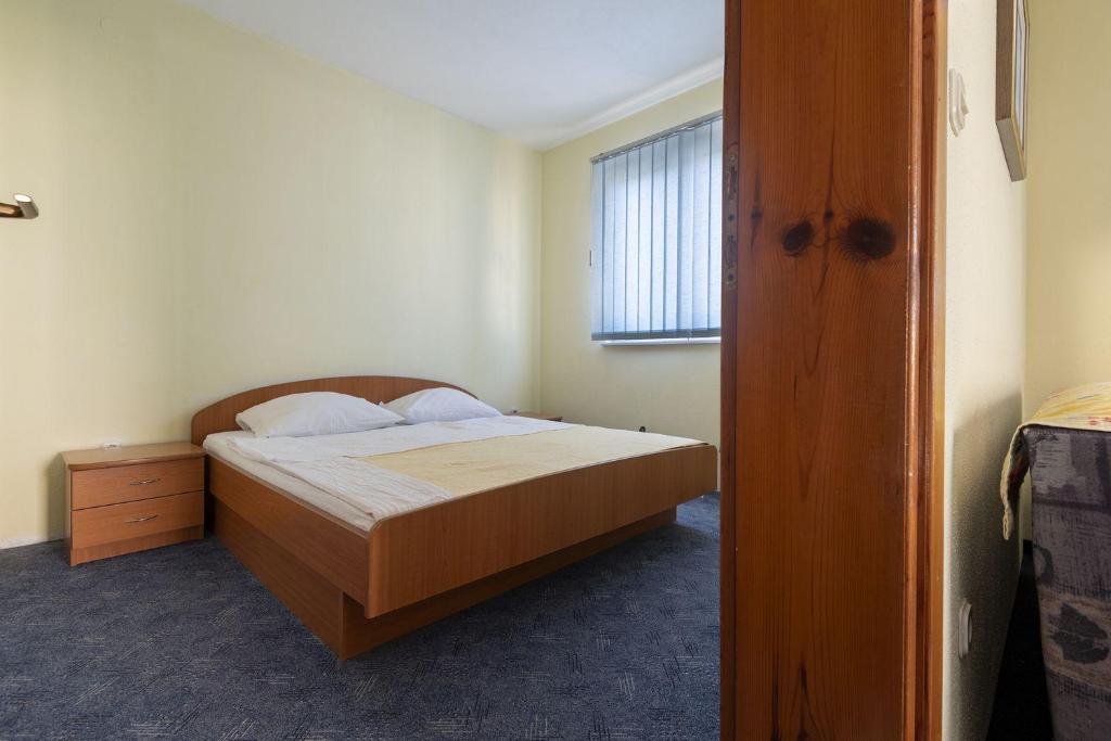 Postel nebo postele na pokoji v ubytování Apartmani Jogunica