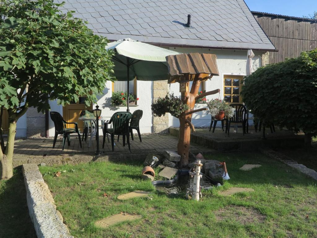 a fire hydrant in the yard of a house at Ferienwohnung Kühnel in Pfaffendorf