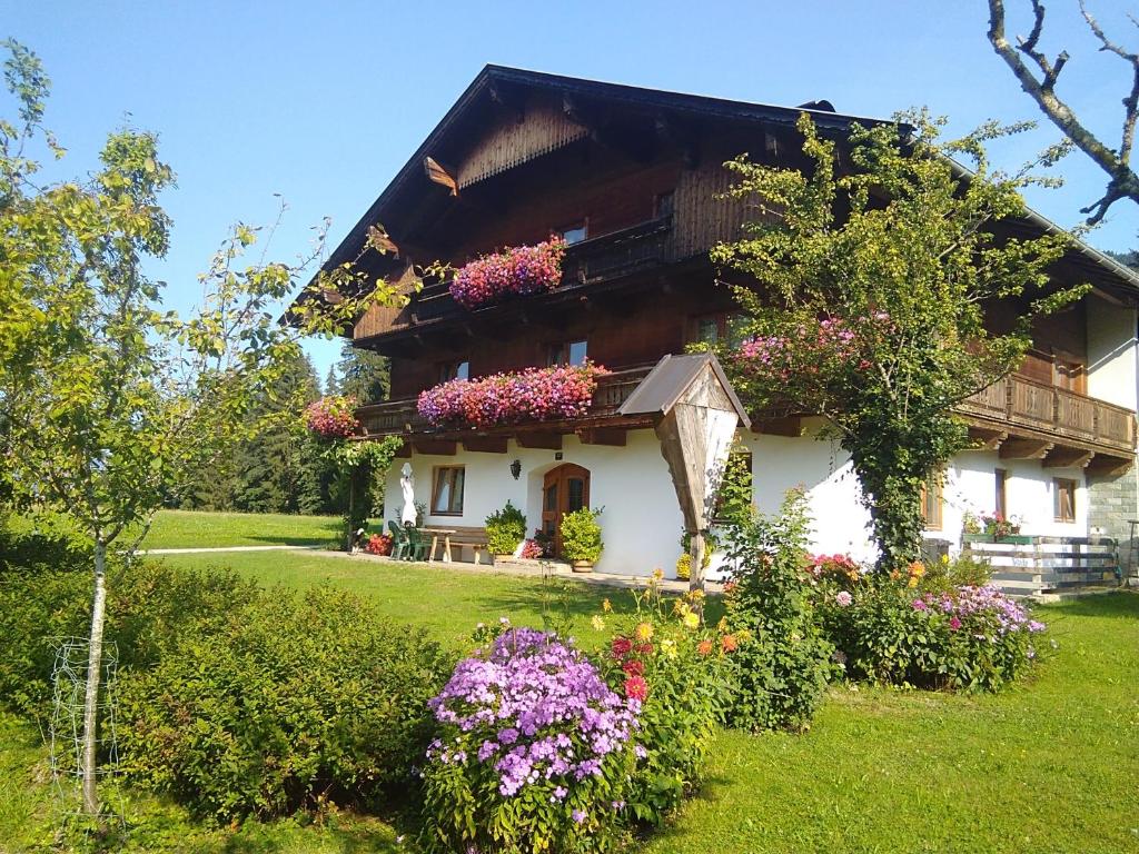 a house with flowers in front of it at Bauernhof Hintenberg in Itter