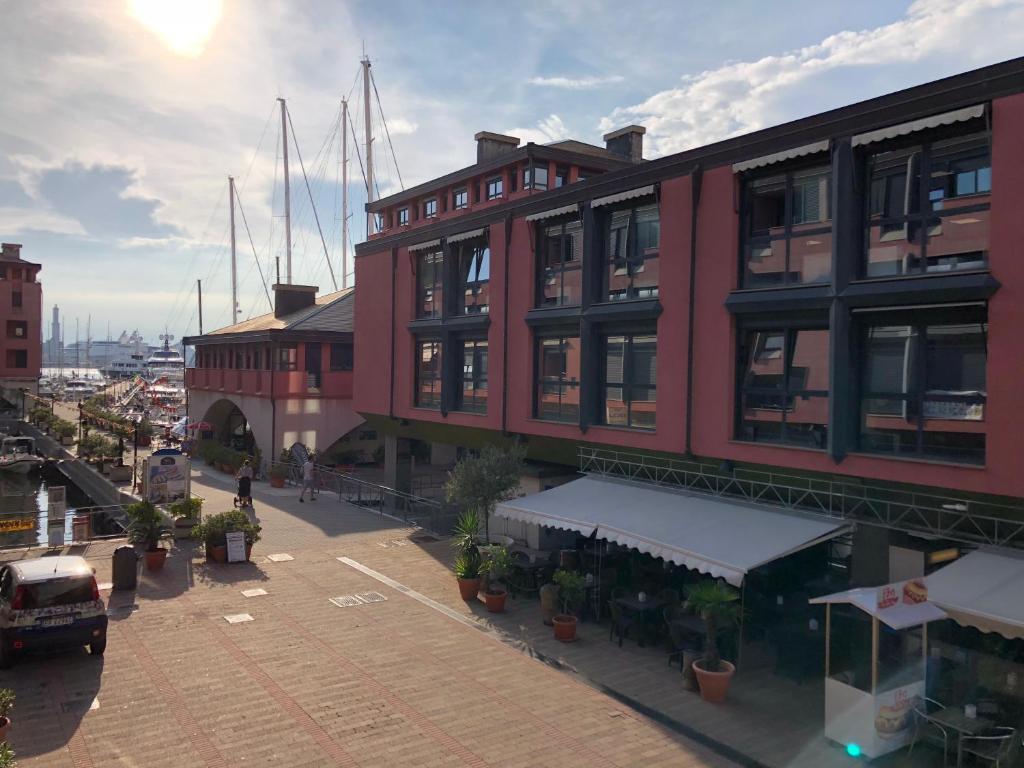 a large red building with plants in front of it at l’Ancora luxury apartment in Genova