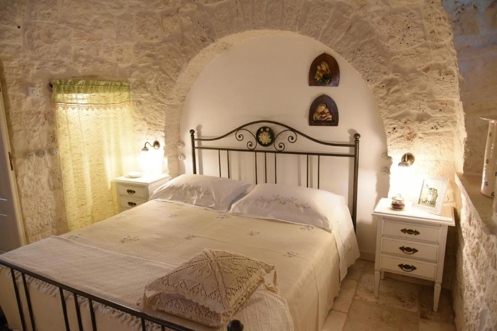 Ένα ή περισσότερα κρεβάτια σε δωμάτιο στο Trulli Occhi Di Pietra