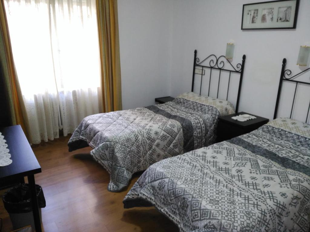 Postel nebo postele na pokoji v ubytování Hotel Vaqueros