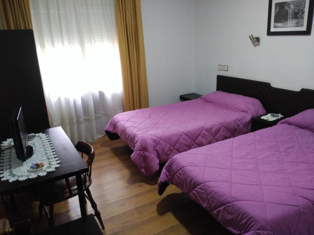 Postel nebo postele na pokoji v ubytování Hotel Vaqueros