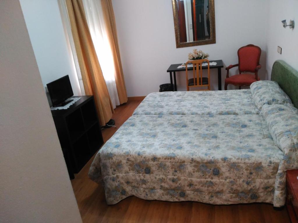 Postel nebo postele na pokoji v ubytování Hotel Vaqueros