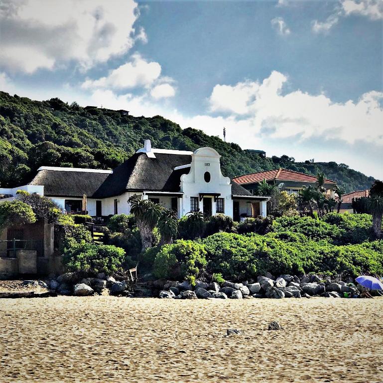 a house on the shore of a beach at Far Niente Beachfront Guesthouse in Wilderness
